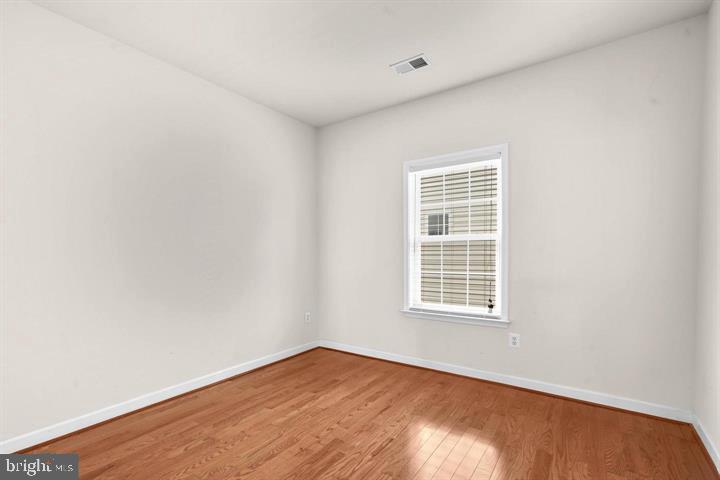 23215 Frederick Road Clarksburg, MD 20871 - Photo 18 of 31 a view of an empty room with wooden floor and a window