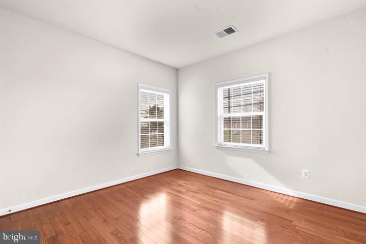 23215 Frederick Road Clarksburg, MD 20871 - Photo 20 of 31 an empty room with wooden floor and windows