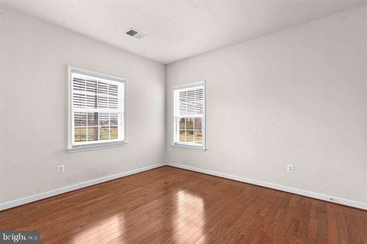 23215 Frederick Road Clarksburg, MD 20871 - Photo 22 of 31 a view of an empty room with wooden floor and a window