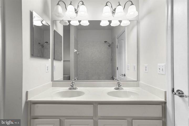 23215 Frederick Road Clarksburg, MD 20871 - Photo 24 of 31 a bathroom with a sink vanity and a mirror