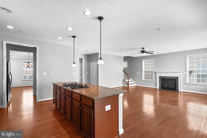 23215 Frederick Road Clarksburg, MD 20871 - Photo 5 of 31 a kitchen with stainless steel appliances granite countertop a kitchen island a stove and a wooden floor