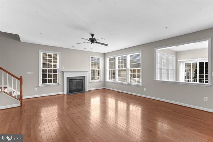23215 Frederick Road Clarksburg, MD 20871 - Photo 9 of 31 a view of an empty room with wooden floor and a window
