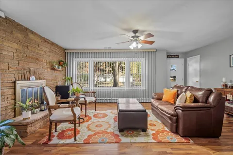a living room with furniture a rug and a chandelier