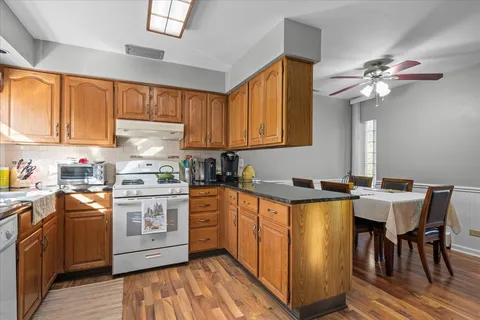 a kitchen with stainless steel appliances granite countertop a stove a sink dishwasher and a refrigerator