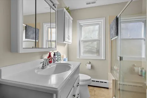 a bathroom with a sink toilet and shower