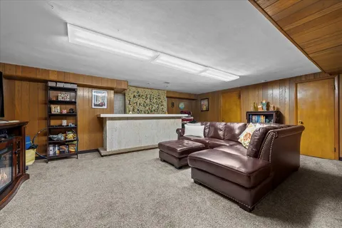 a living room with furniture and a bookshelf