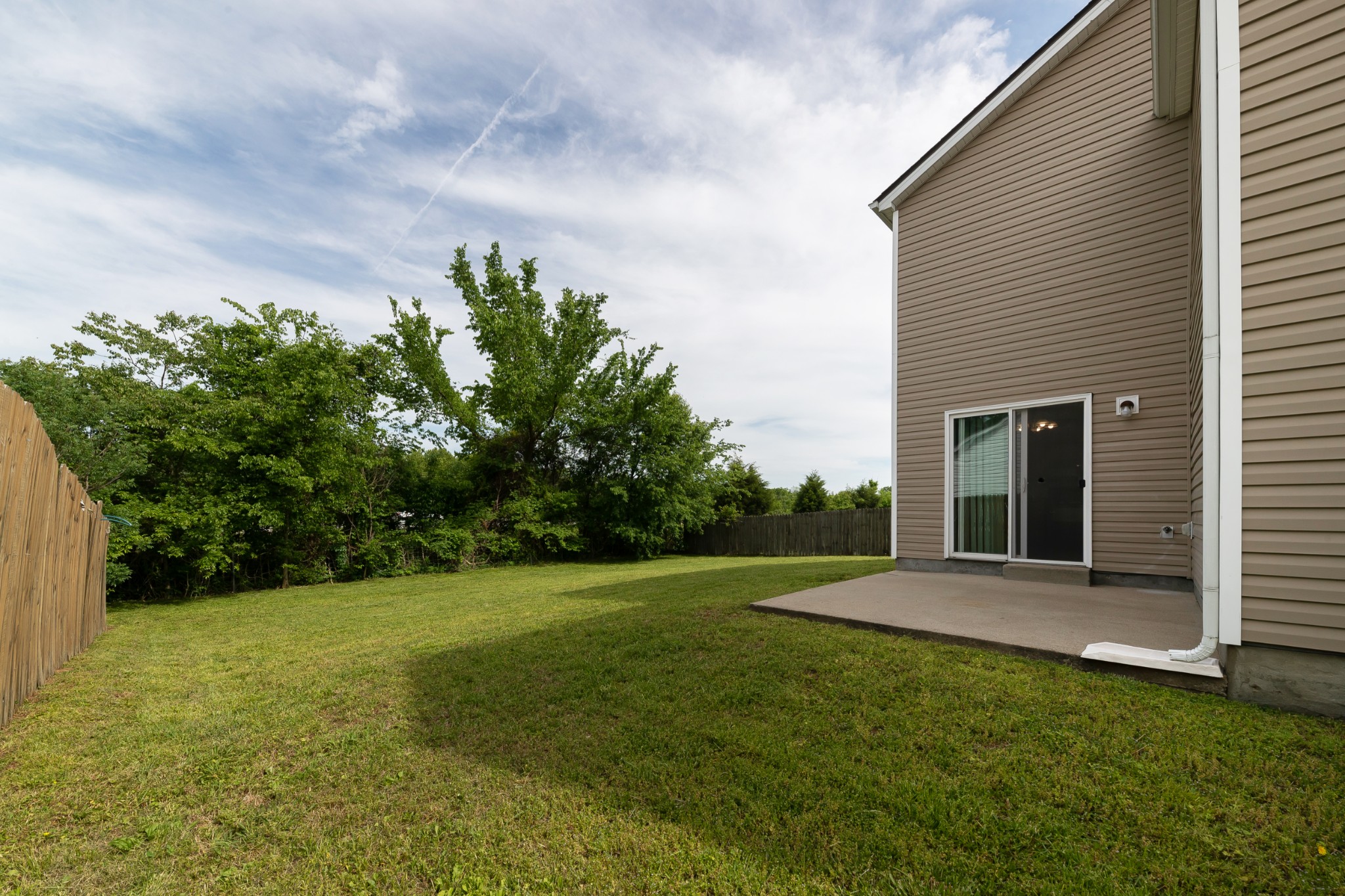 921 Woodall Road Lebanon, TN 37090 - Photo 27 of 30 a backyard of a house with plants and large tree