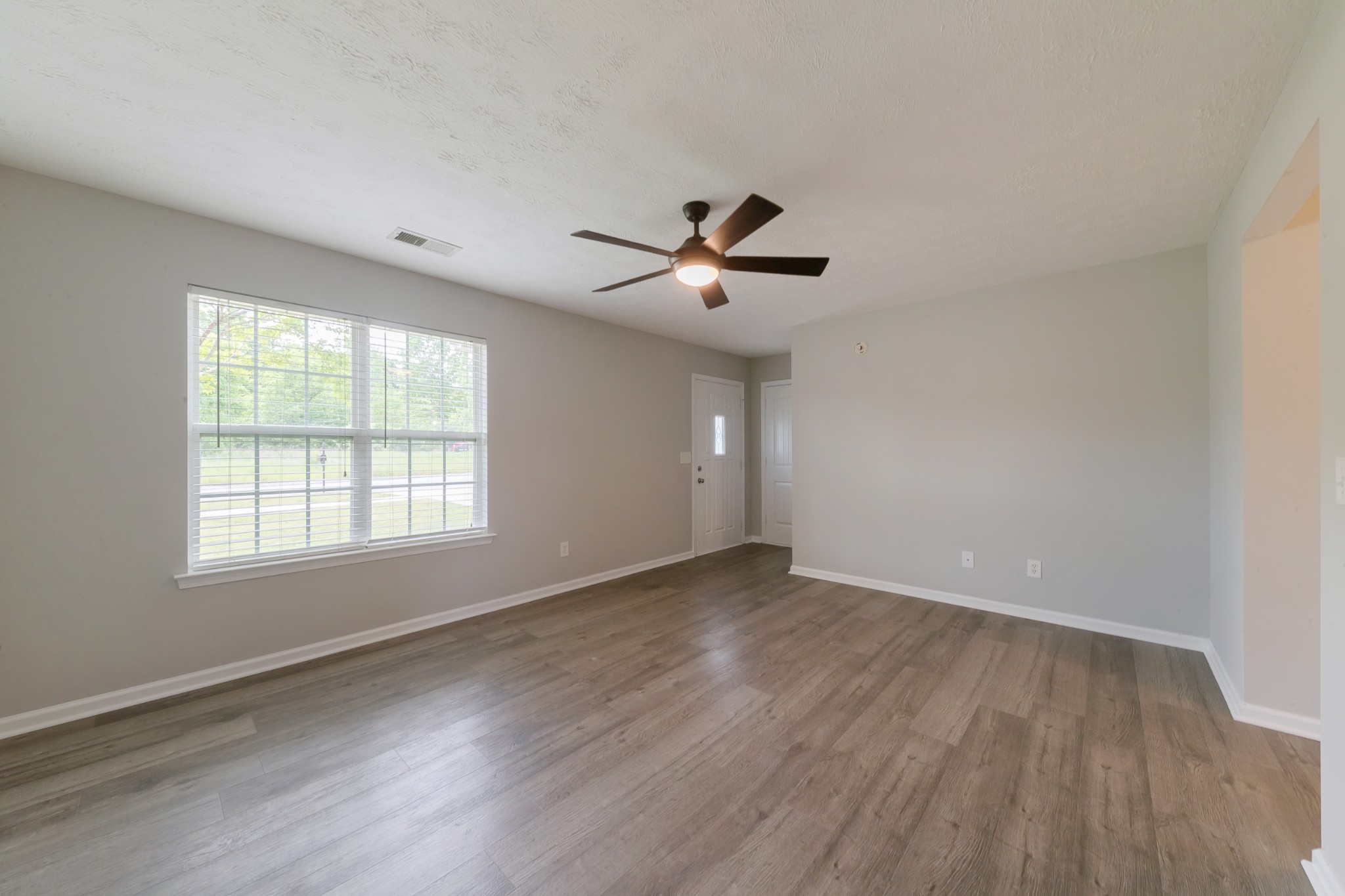 921 Woodall Road Lebanon, TN 37090 - Photo 8 of 30 an empty room with wooden floor and windows