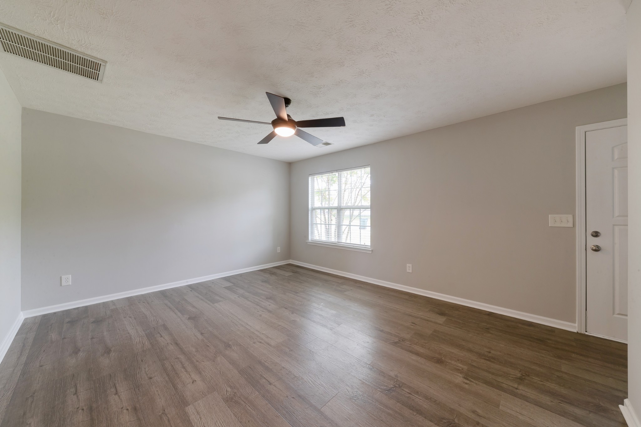 921 Woodall Road Lebanon, TN 37090 - Photo 9 of 30 a view of an empty room with wooden floor and a window
