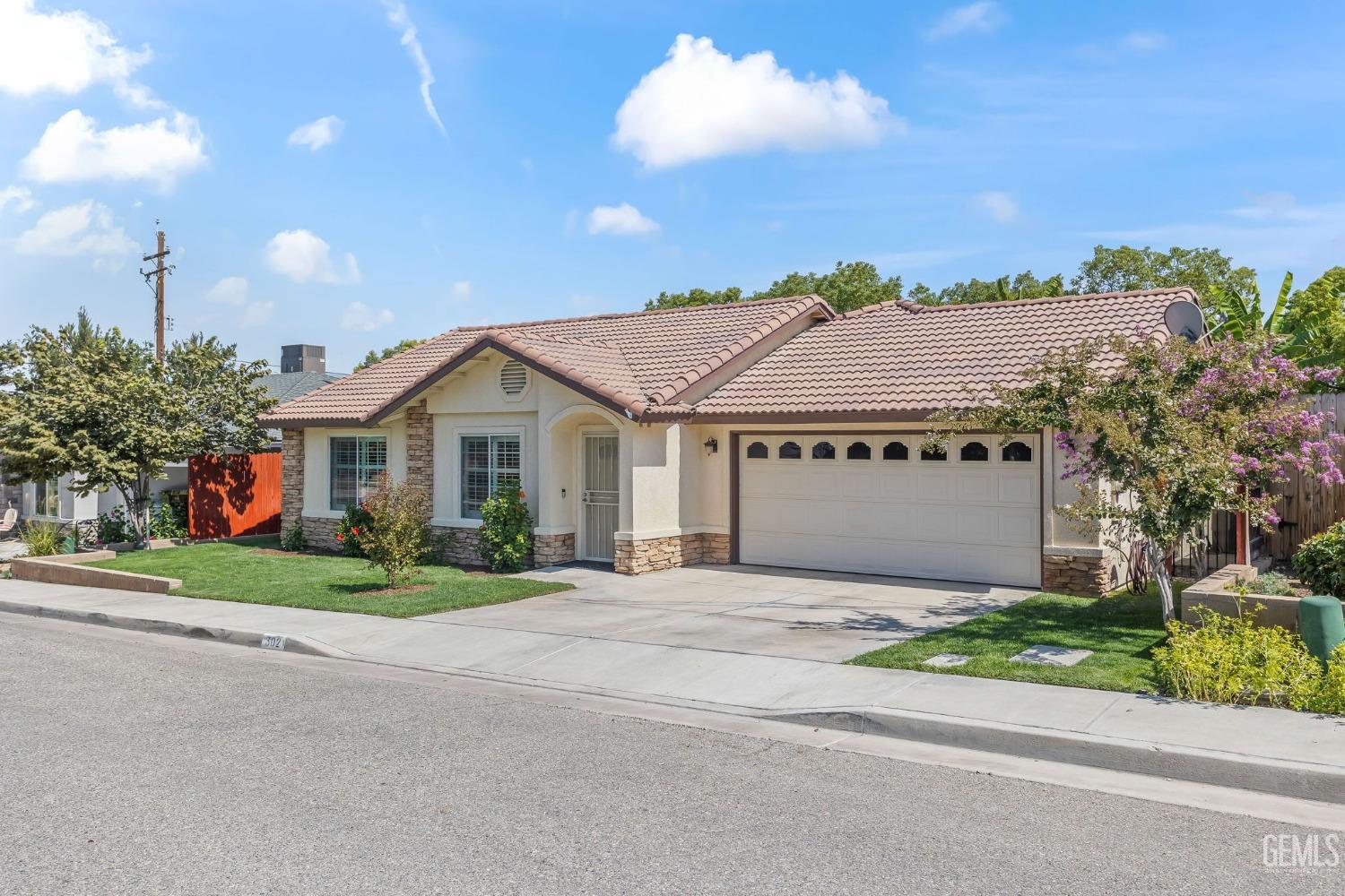 Undisclosed Address Taft, CA 93268 - Photo 14 of 60 a front view of a house with a yard and garage