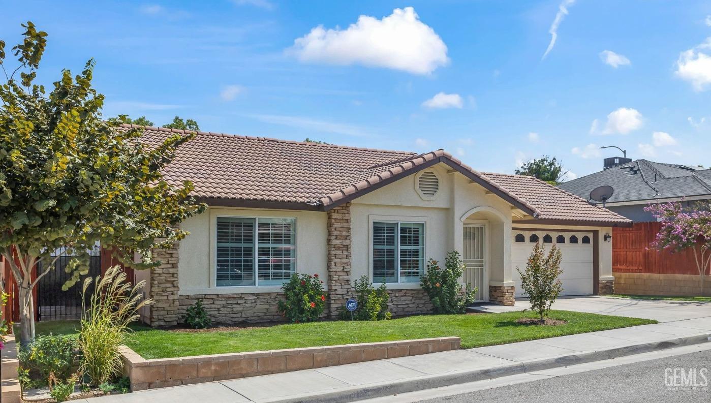 Undisclosed Address Taft, CA 93268 - Photo 2 of 60 a front view of a house with a garden