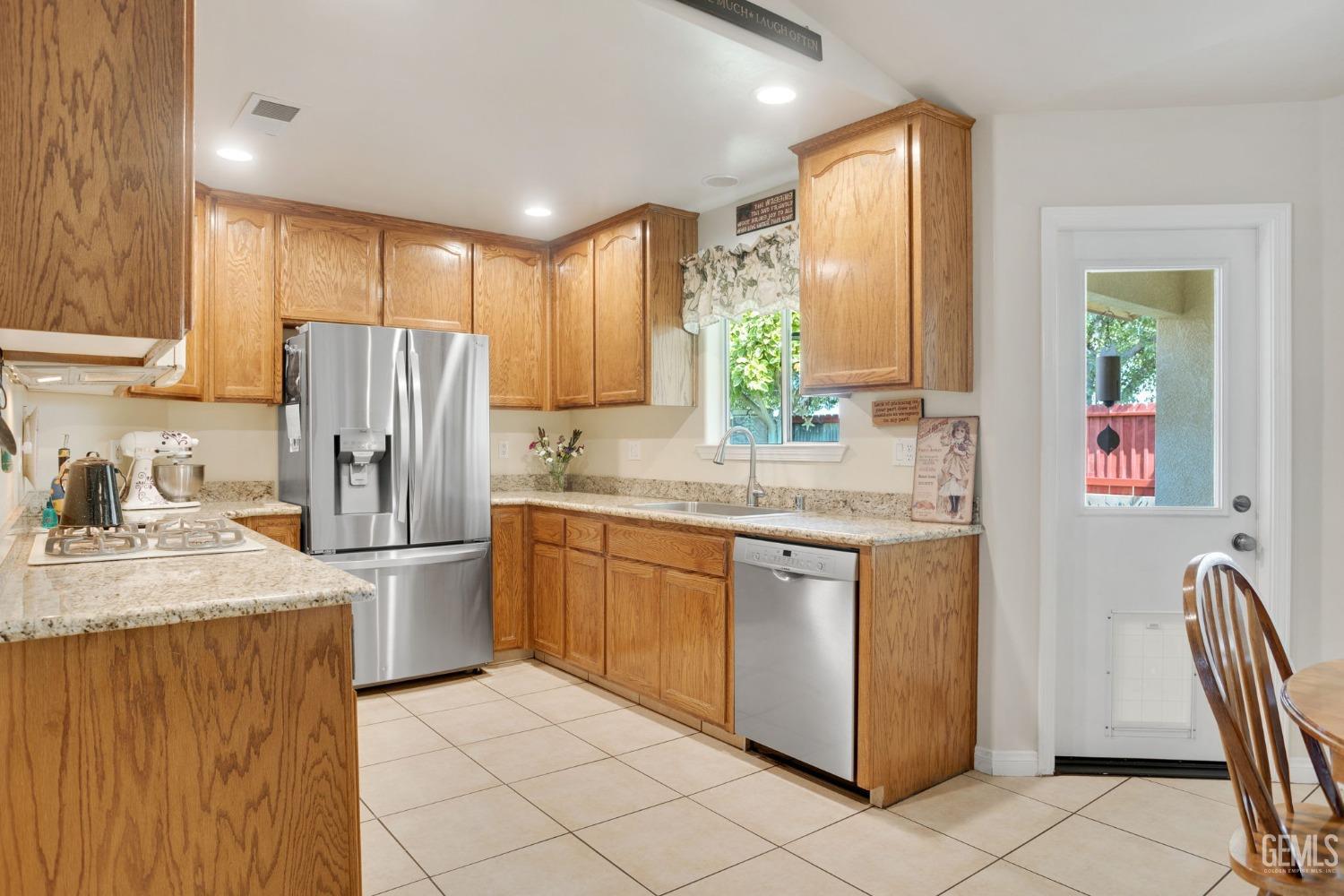Undisclosed Address Taft, CA 93268 - Photo 28 of 60 a kitchen with stainless steel appliances granite countertop a refrigerator a sink a stove with white cabinets