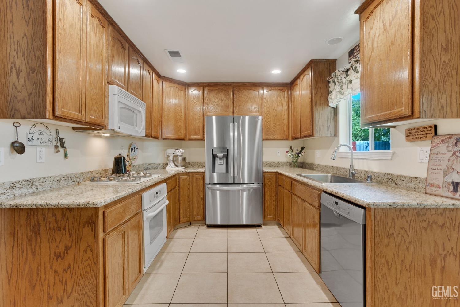 Undisclosed Address Taft, CA 93268 - Photo 30 of 60 a kitchen with stainless steel appliances granite countertop a sink stove refrigerator and cabinets
