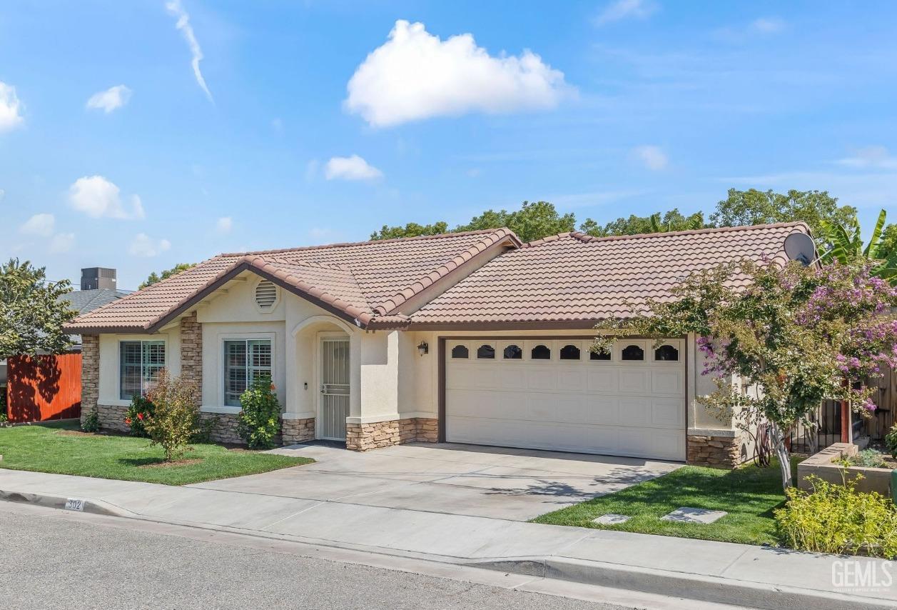 Undisclosed Address Taft, CA 93268 - Photo 3 of 60 a front view of a house with a yard and garage