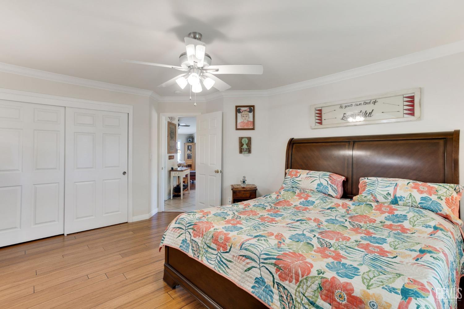 Undisclosed Address Taft, CA 93268 - Photo 37 of 60 a bedroom with a bed and wooden floor