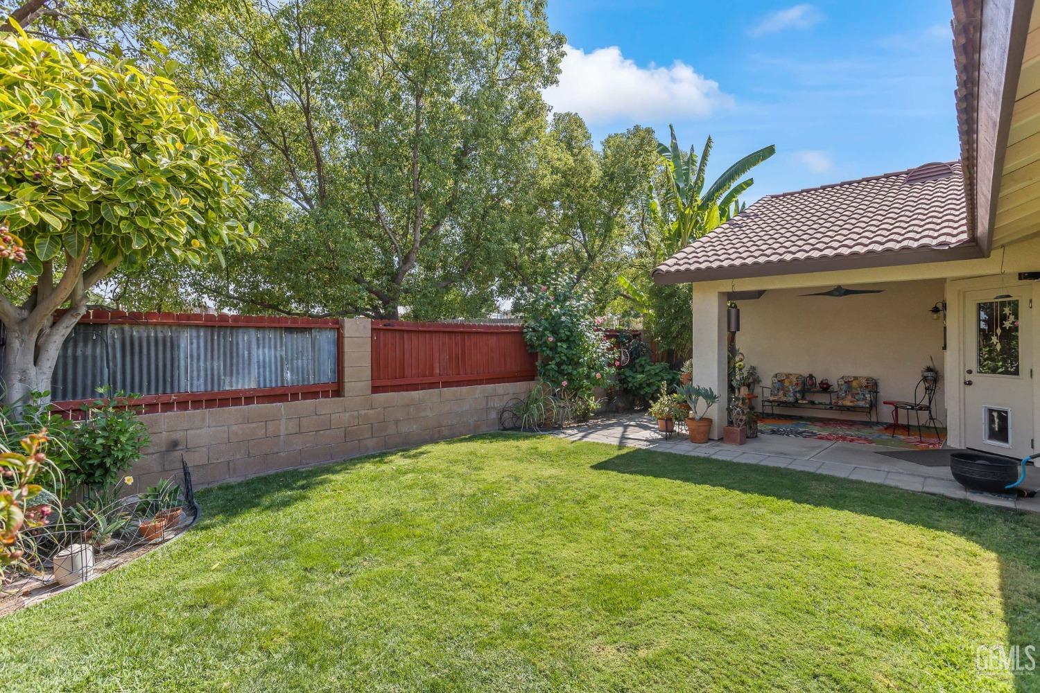 Undisclosed Address Taft, CA 93268 - Photo 49 of 60 a view of a backyard with table and chairs and wooden fence