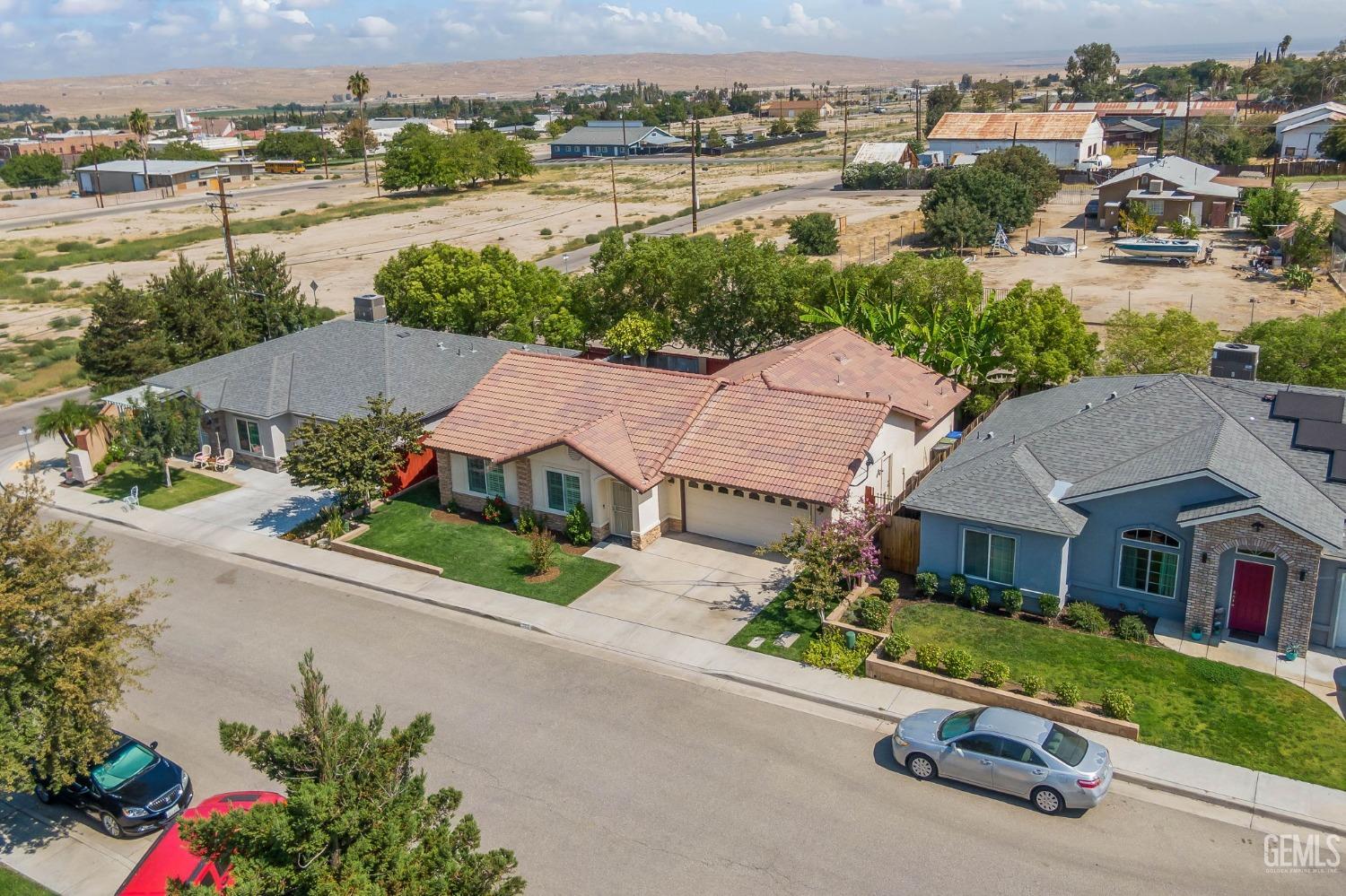 Undisclosed Address Taft, CA 93268 - Photo 53 of 60 an aerial view of a house with a garden and lake view
