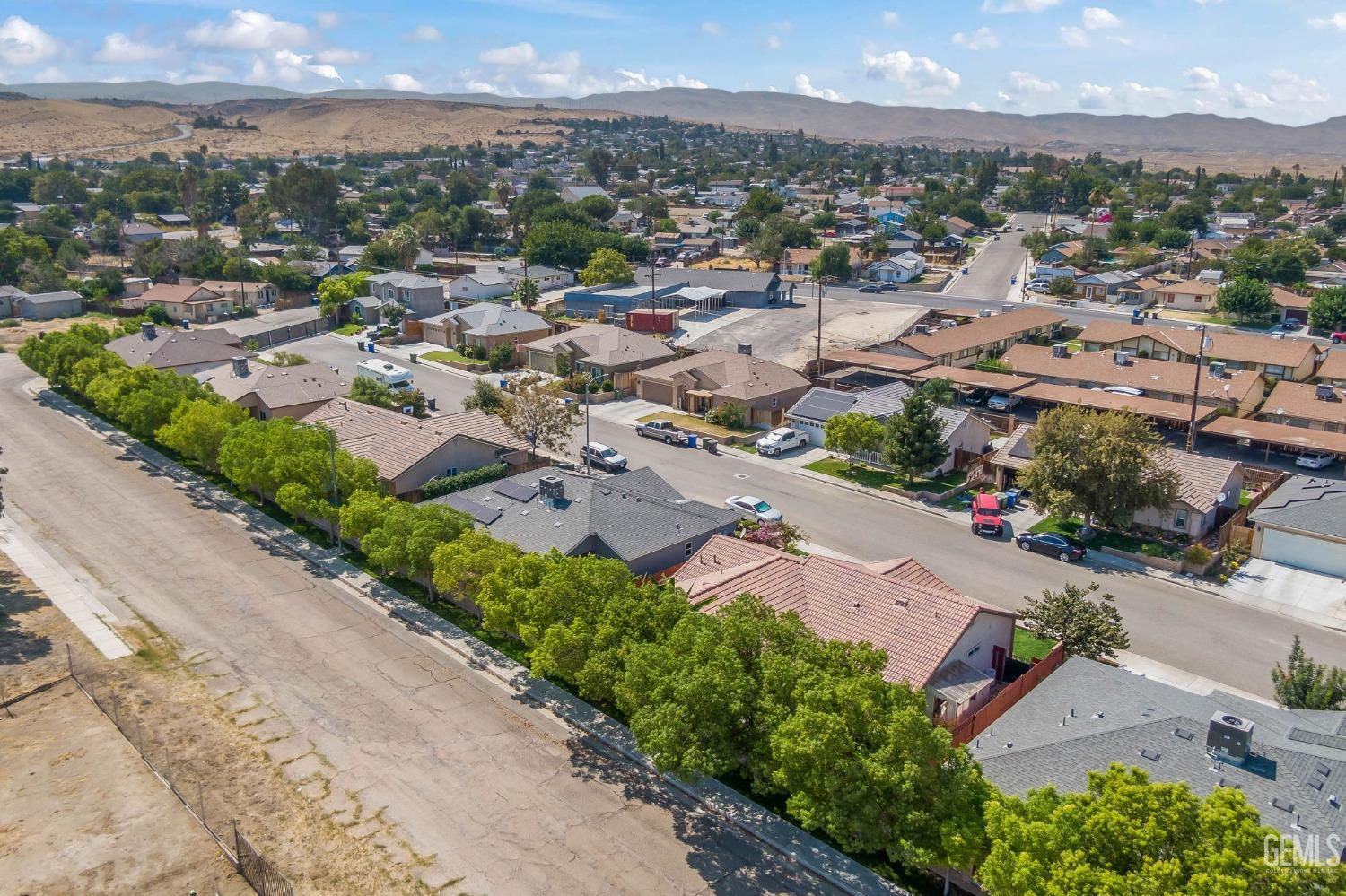Undisclosed Address Taft, CA 93268 - Photo 54 of 60 an aerial view of a city with lots of residential buildings ocean and mountain view in back