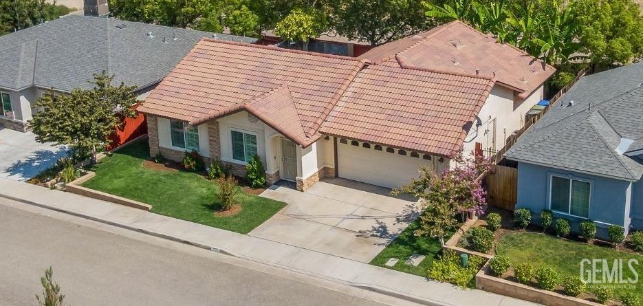 Undisclosed Address Taft, CA 93268 - Photo 58 of 60 a view of a white house with a yard and potted plants