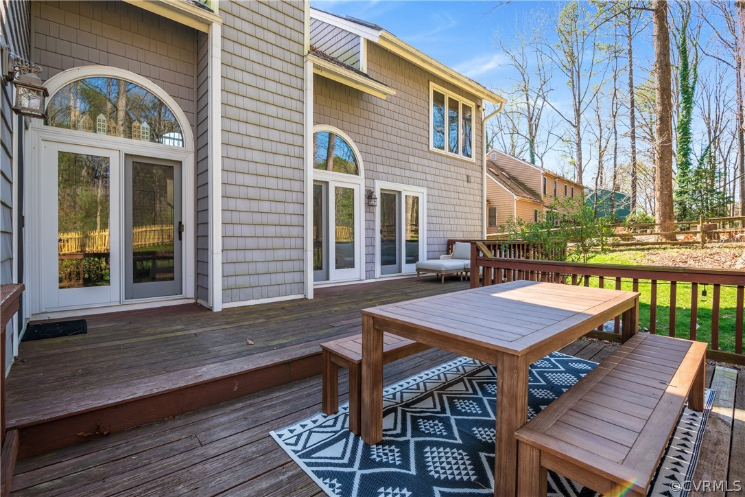 6218 Willow Glen Road Midlothian, VA 23112 - Photo 33 of 45 a view of a patio with table and chairs with wooden floor and fence