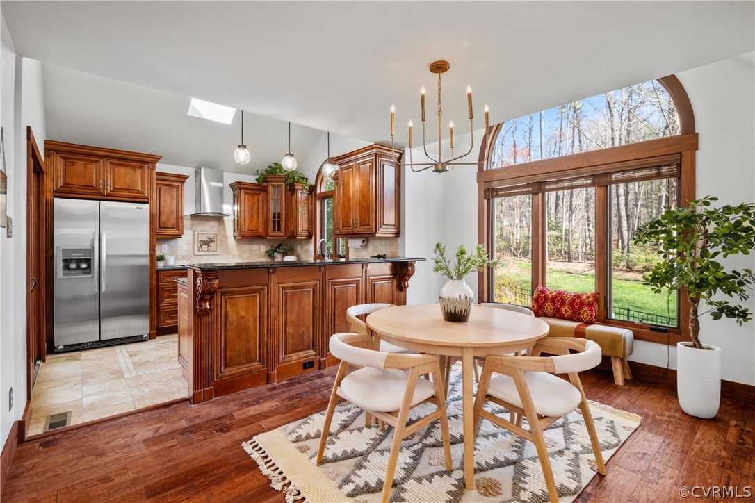 6218 Willow Glen Road Midlothian, VA 23112 - Photo 8 of 45 a kitchen with stainless steel appliances kitchen island granite countertop a refrigerator a stove a sink dishwasher and a dining table with wooden floor