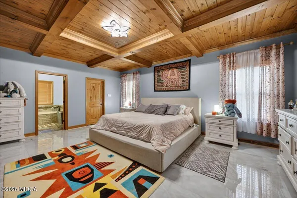 a spacious bedroom with a bed and a chandelier