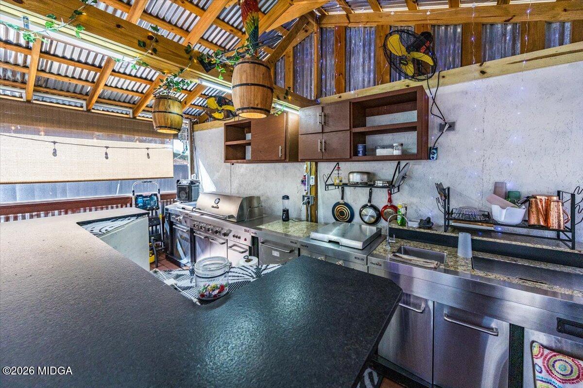 306 Thomson Street Centerville, GA 31028 - Photo 21 of 38 a room with lots of clutter and lots of appliances