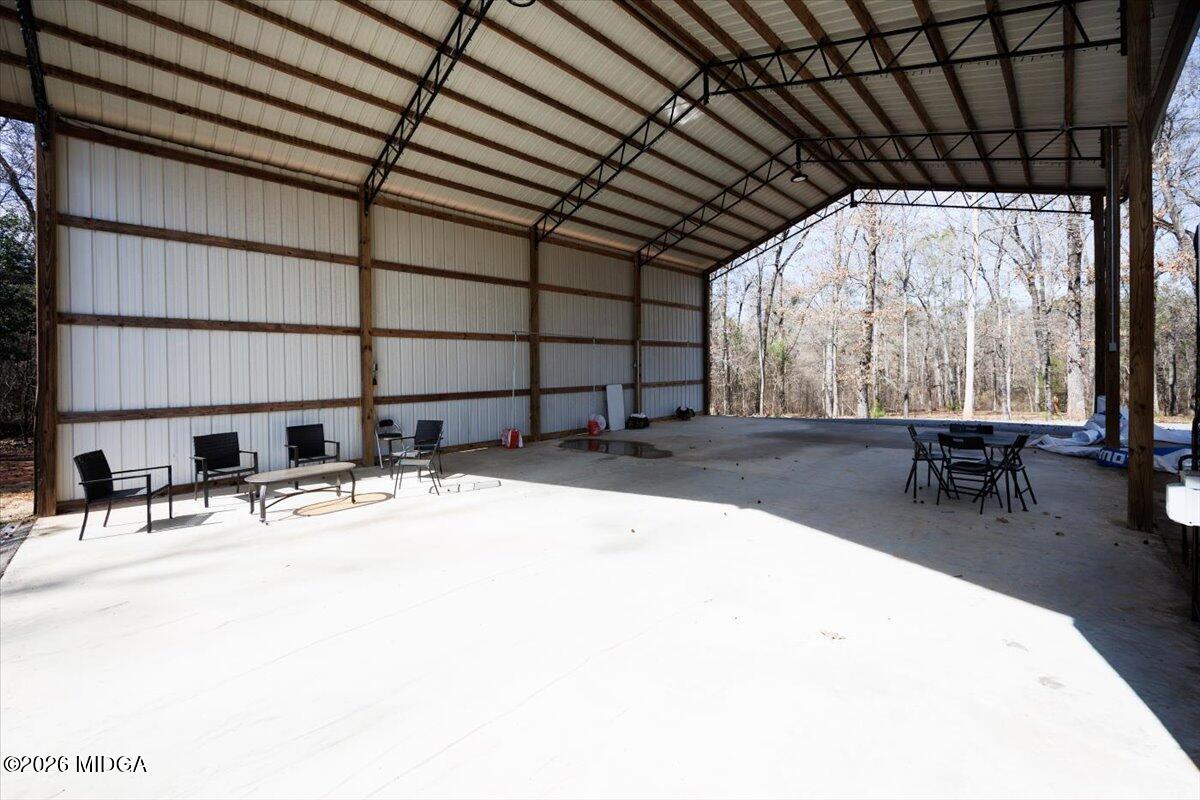 306 Thomson Street Centerville, GA 31028 - Photo 30 of 38 a view of a patio with table and chairs with wooden floor and plants