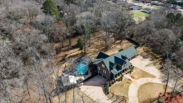 an aerial view of a house with yard swimming pool and outdoor seating