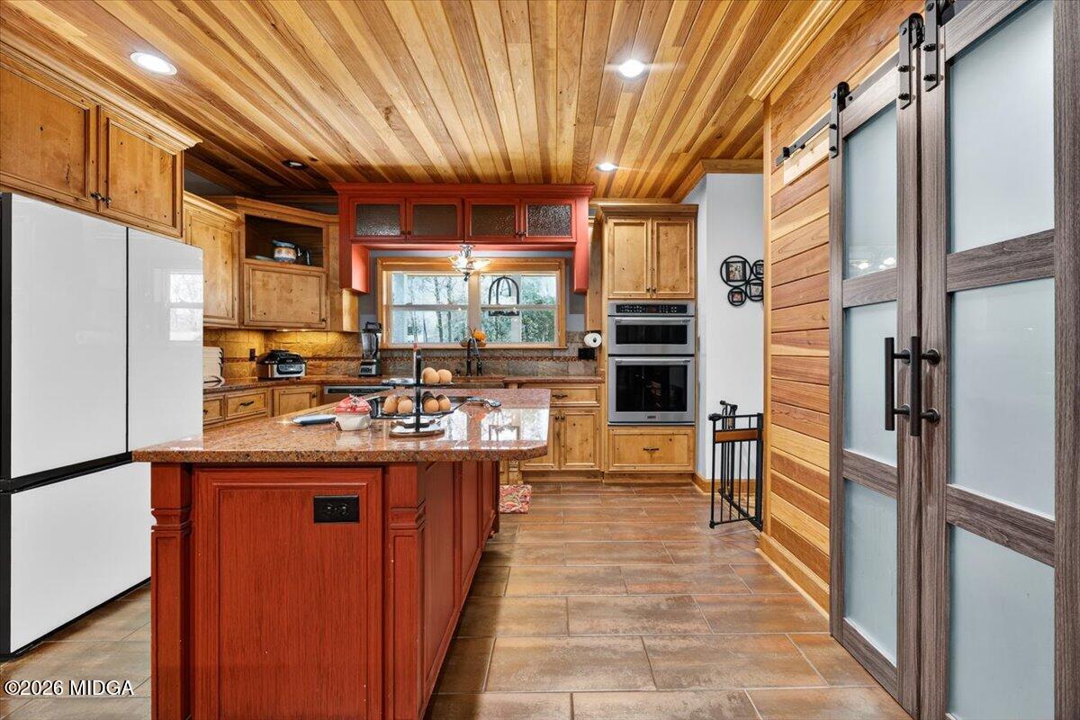 306 Thomson Street Centerville, GA 31028 - Photo 10 of 38 a kitchen with kitchen island a counter top space a sink stainless steel appliances and cabinets
