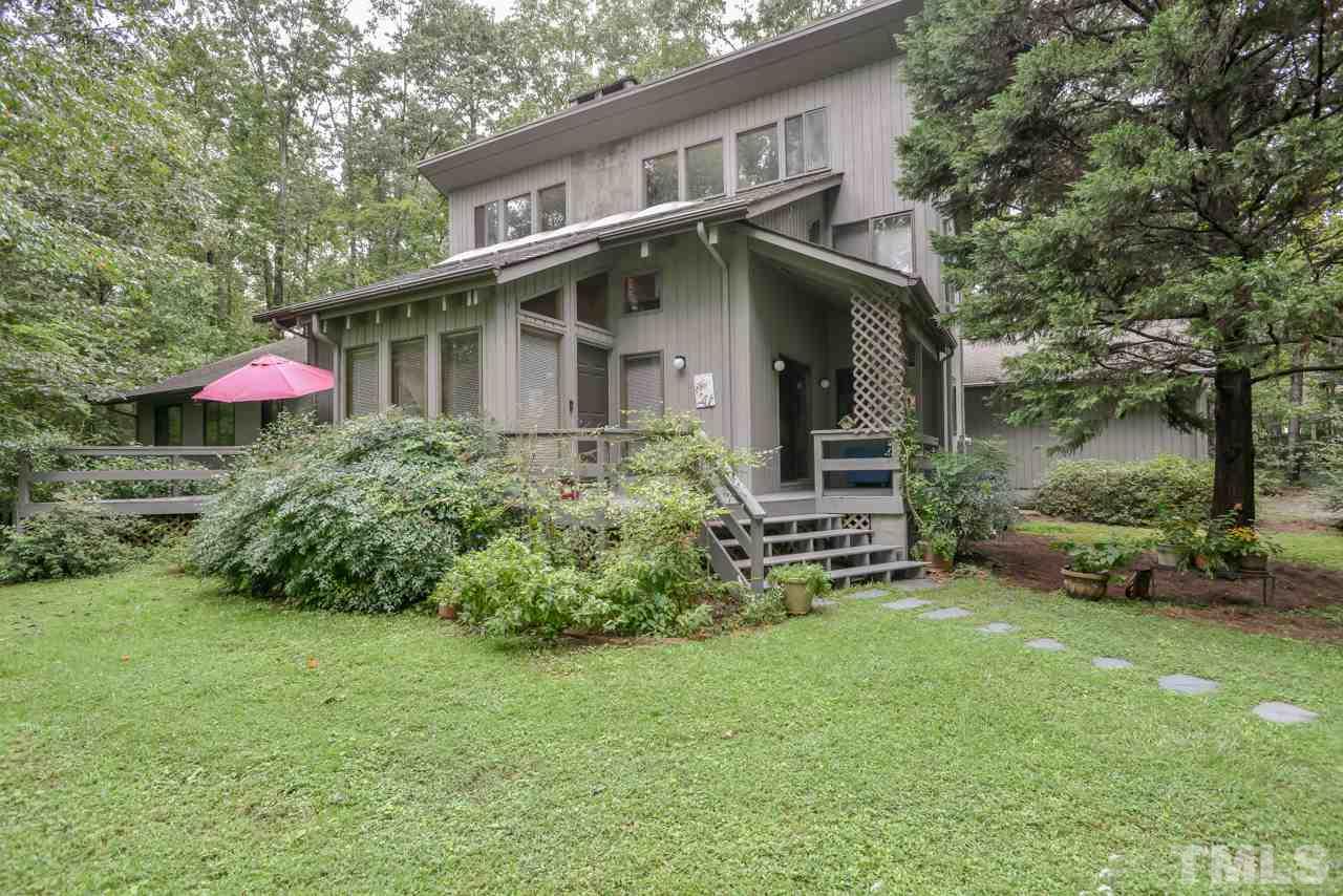 214 Clark Lake Road Durham, NC 27707 - Photo 1 of 30 a front view of a house with a garden