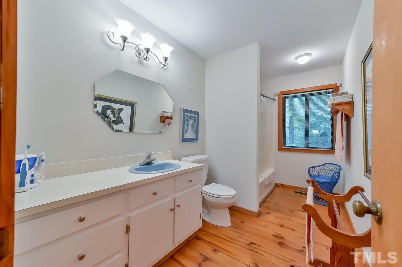 214 Clark Lake Road Durham, NC 27707 - Photo 11 of 30 a spacious bathroom with a toilet sink and mirror