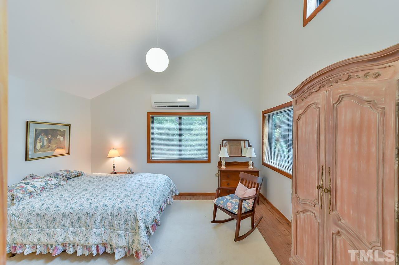 214 Clark Lake Road Durham, NC 27707 - Photo 21 of 30 a bedroom with a bed and a window