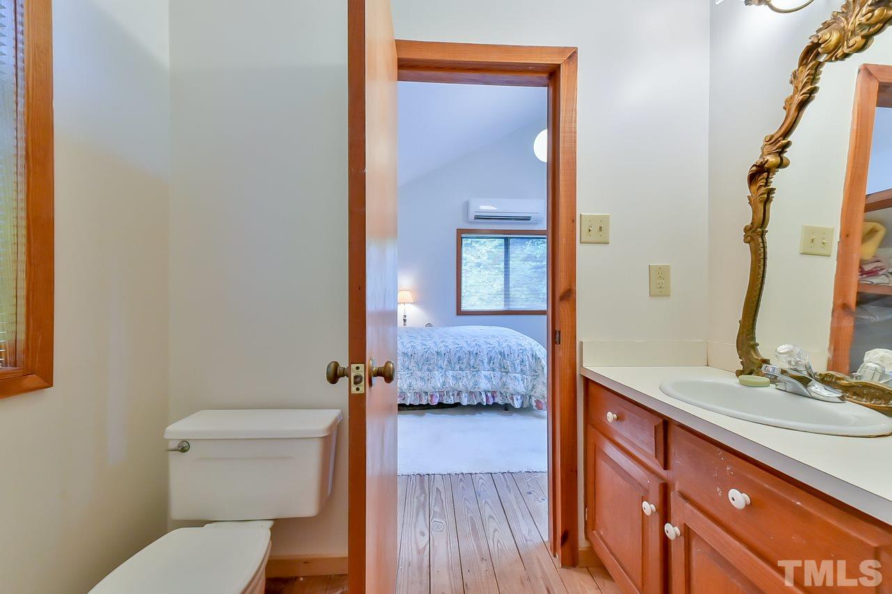 214 Clark Lake Road Durham, NC 27707 - Photo 23 of 30 a en suite bathroom with a granite countertop sink and a mirror