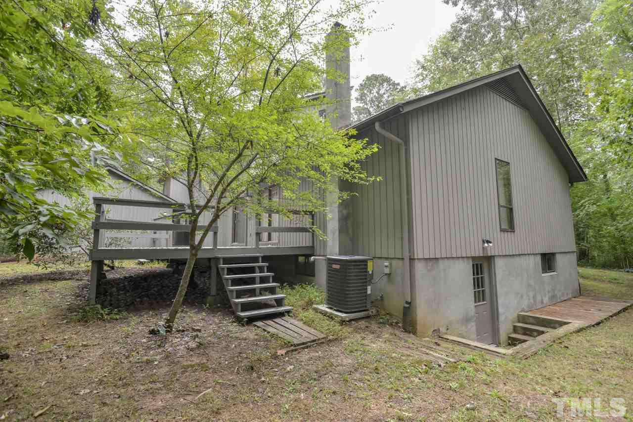 214 Clark Lake Road Durham, NC 27707 - Photo 27 of 30 a view of backyard with wooden fence and large trees