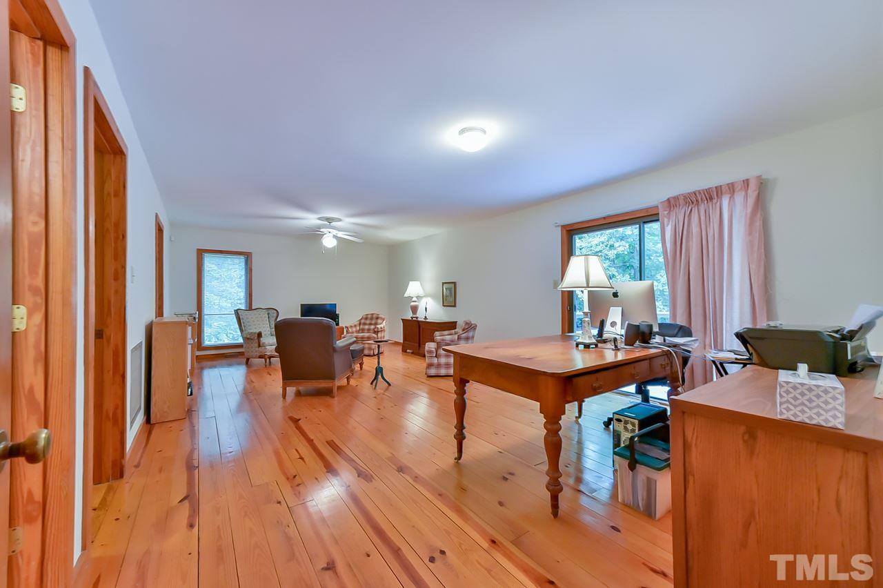214 Clark Lake Road Durham, NC 27707 - Photo 10 of 30 a living room with furniture a wooden floor and a window
