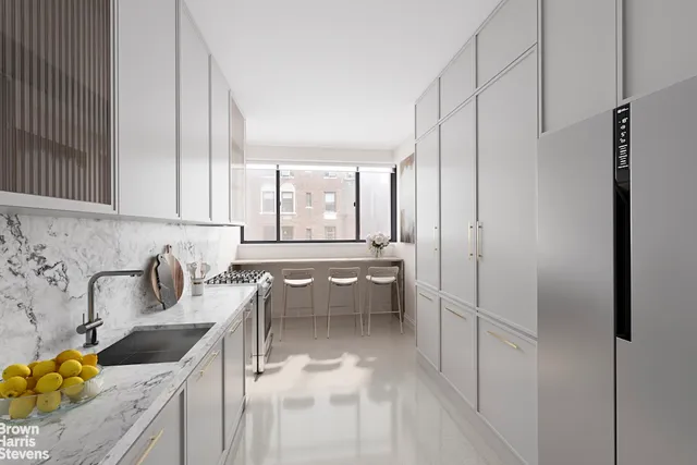 a kitchen with a sink a counter top space stainless steel appliances a large window and cabinets