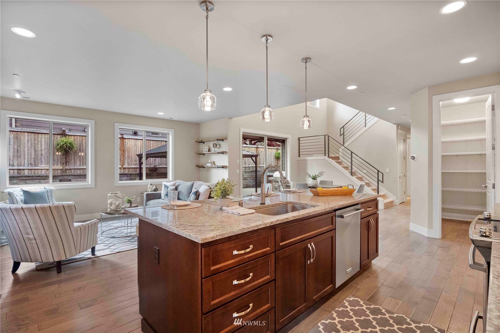 24212 23rd Avenue West Bothell, WA 98021 - Photo 21 of 40 a kitchen with a stove a kitchen island a sink and a wooden floor