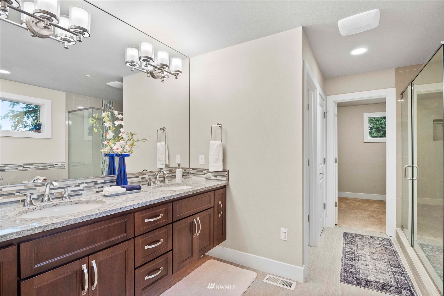 24212 23rd Avenue West Bothell, WA 98021 - Photo 33 of 40 a bathroom with a double vanity sink and mirror with shower