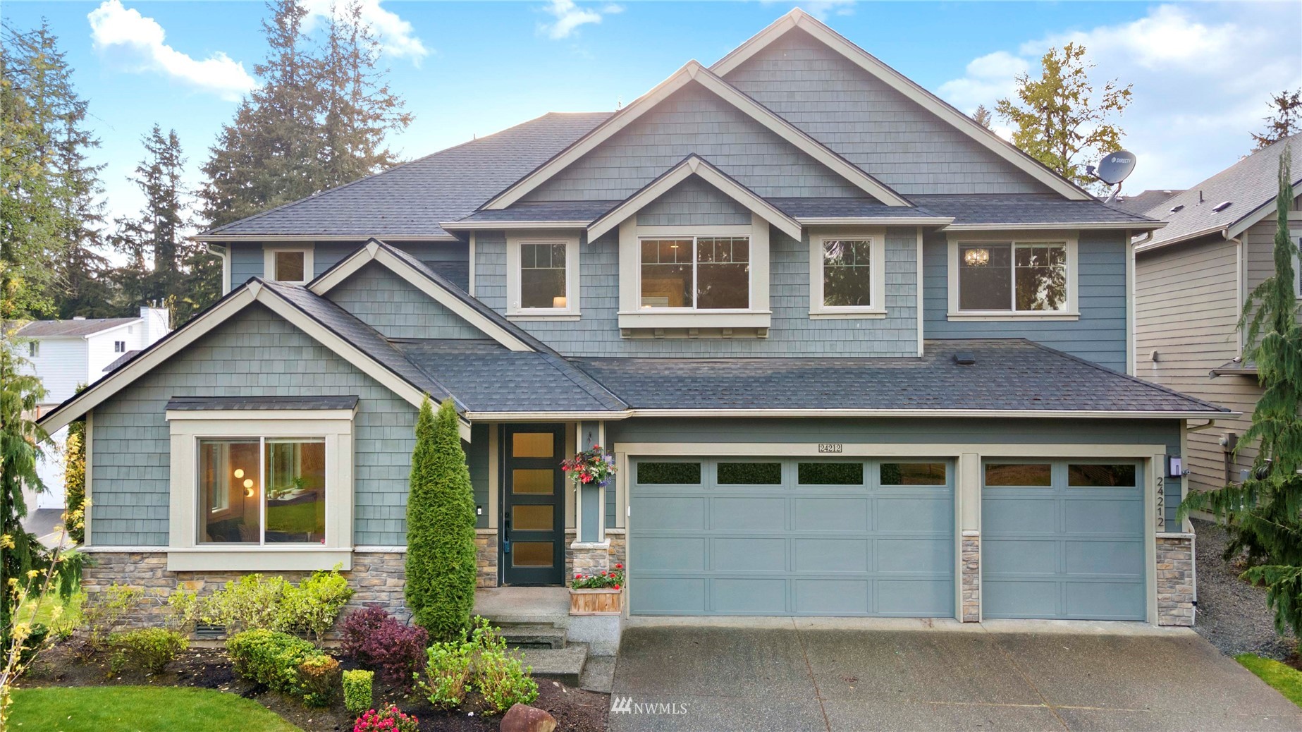 24212 23rd Avenue West Bothell, WA 98021 - Photo 4 of 40 a front view of a house with a yard and garage