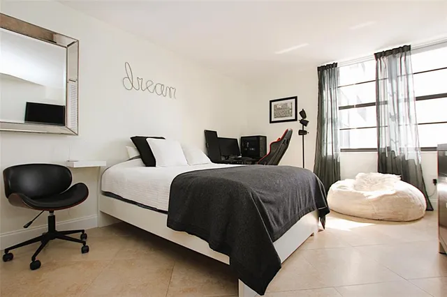 a bedroom with a bed and window