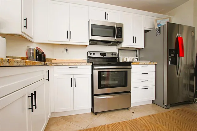 a kitchen with a refrigerator and a window