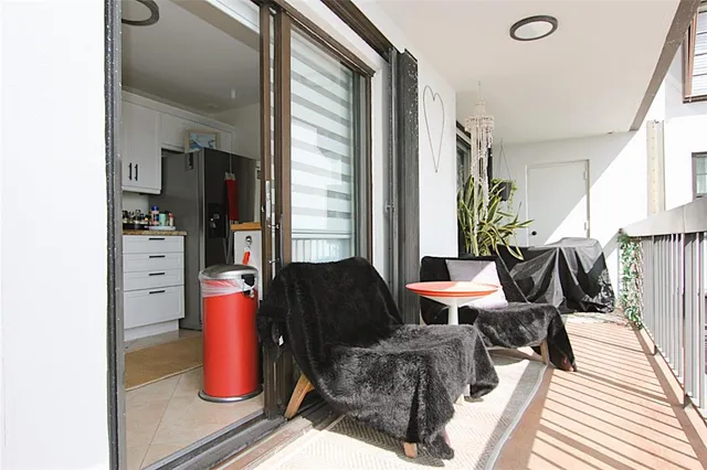 a view of balcony with wooden floor and fence