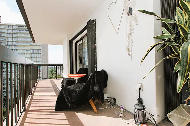 a view of balcony with wooden floor