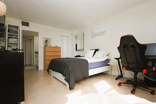 a bedroom with a bed and dresser