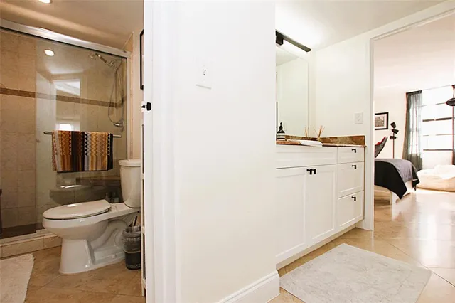 a bathroom with a toilet a sink and mirror