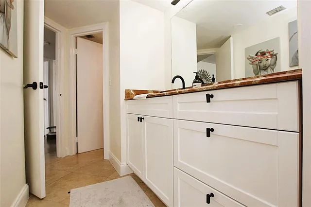 a bathroom with a sink and mirror