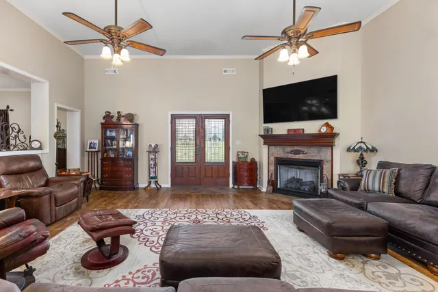 a living room with furniture a flat screen tv and a fireplace