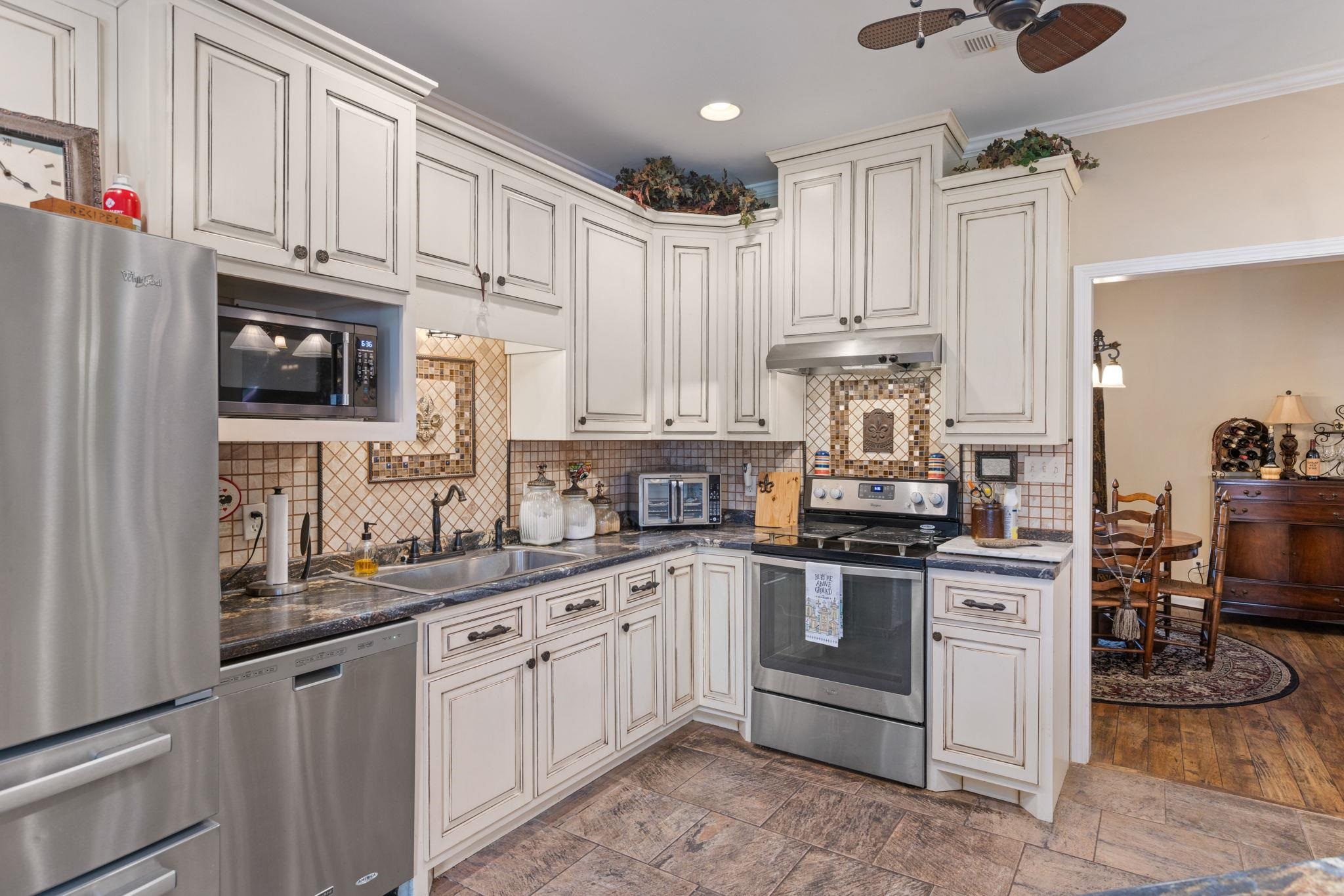 27 Bynum Drive Corinth, MS 38834 - Photo 7 of 36 a kitchen with stainless steel appliances granite countertop a sink stove and refrigerator