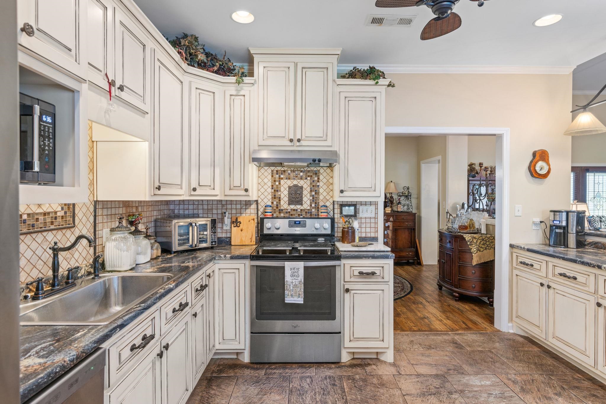 27 Bynum Drive Corinth, MS 38834 - Photo 8 of 36 a kitchen with stainless steel appliances granite countertop a sink stove and refrigerator
